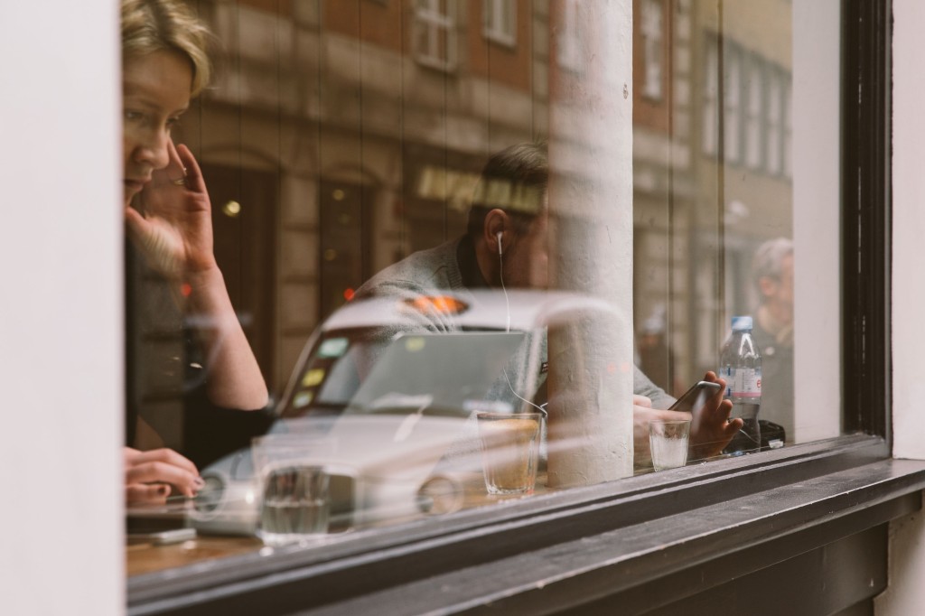 Woman at window of cafe in Soho