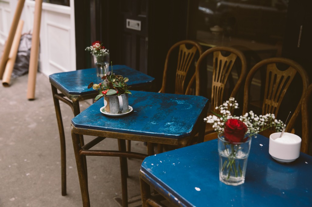 Blue tables with flower vases outside
