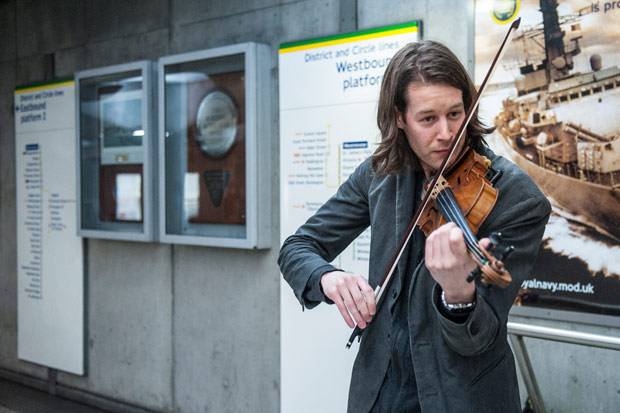 Thomas Gould busking in Westminster Underground station.